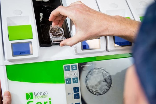 Person putting a dish containing embryos in to a GERI IVF incubator