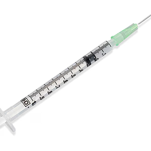 Medical syringe with a clear needle on a white background