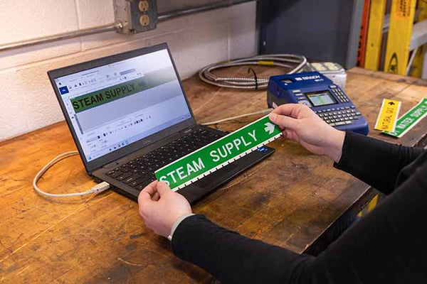 M510 Label Printer printing on green labels in large text