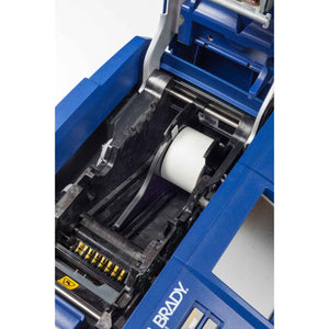 Media adapter installed on a label printer, showing the device snap onto the roll of labels.