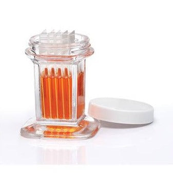 Coplin Staining Jar with an orange product stored inside with the white lid leaning against the glass clear jar. 